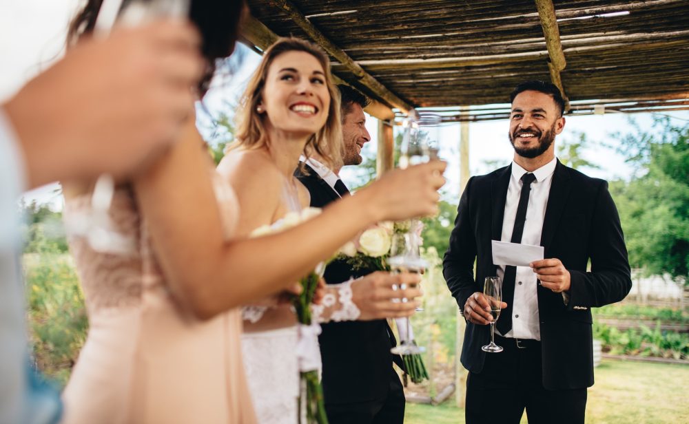 Man Gives speech at outdoor wedding
