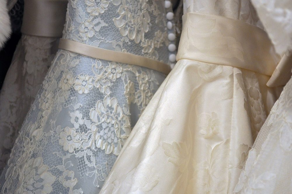 Close up shot of several wedding gowns in different tones and patterns