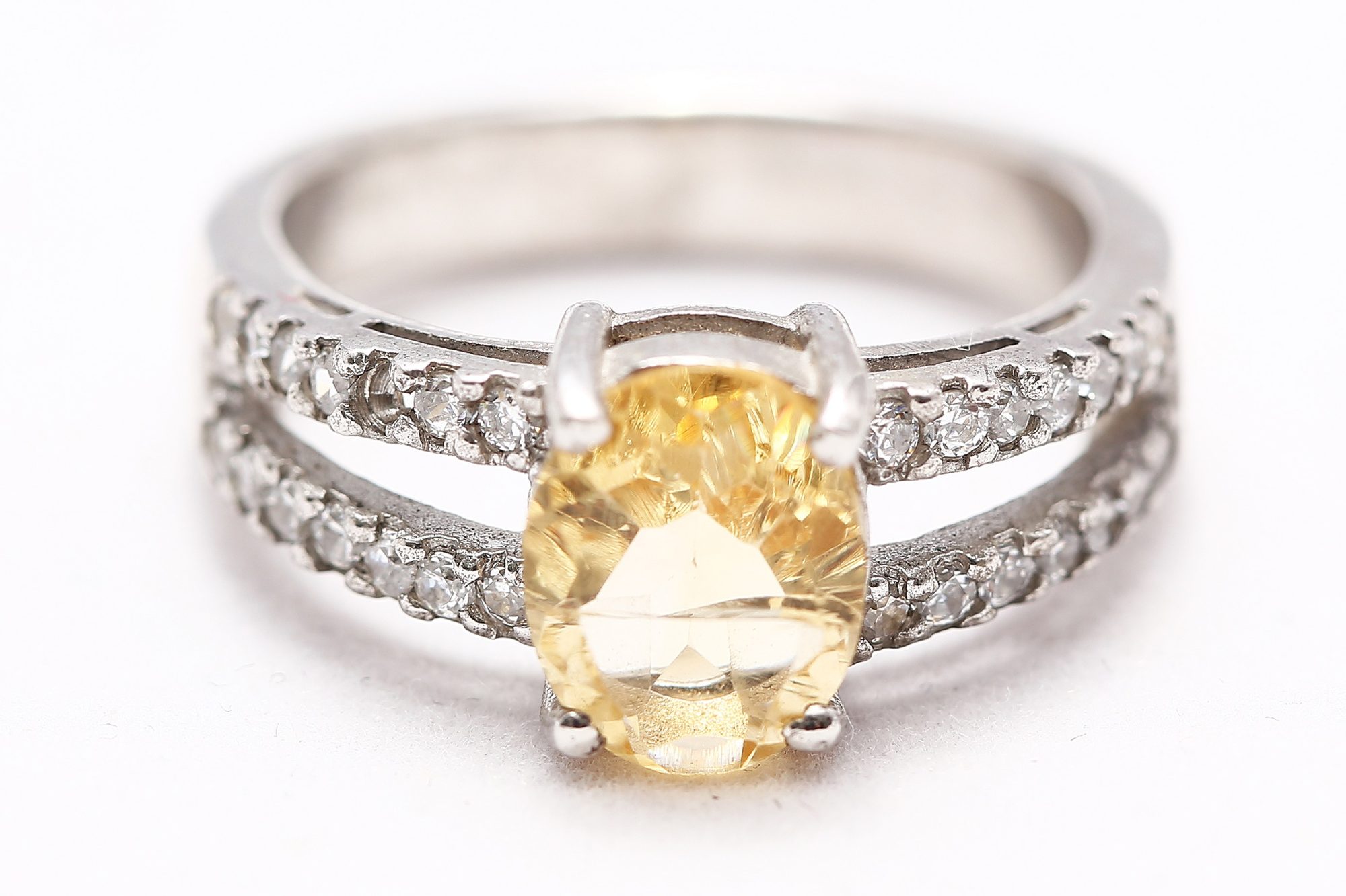 A white gold citrine ring with a diamond pavé setting