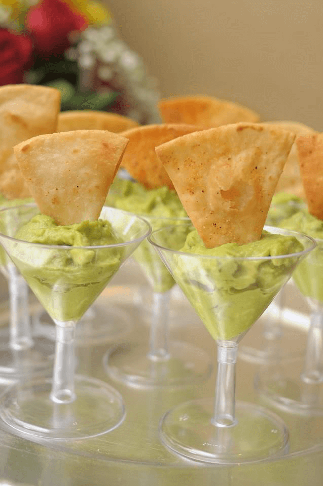 Guacamole in Cocktail Glasses with Crisps Dipped In