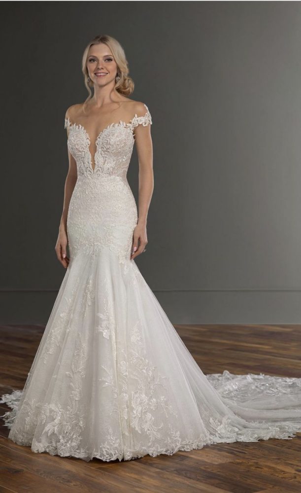 beautiful lace off-the-shoulder fit-and-flare bridal gown.