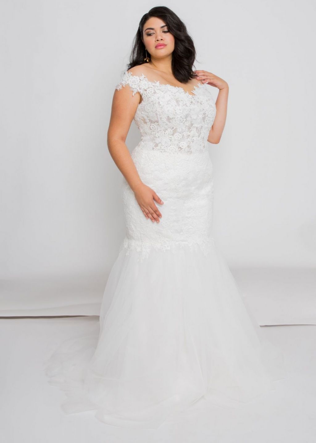 bride posing in Audie wedding dress by Leigh & Siena a beautiful plus size lace wedding dress