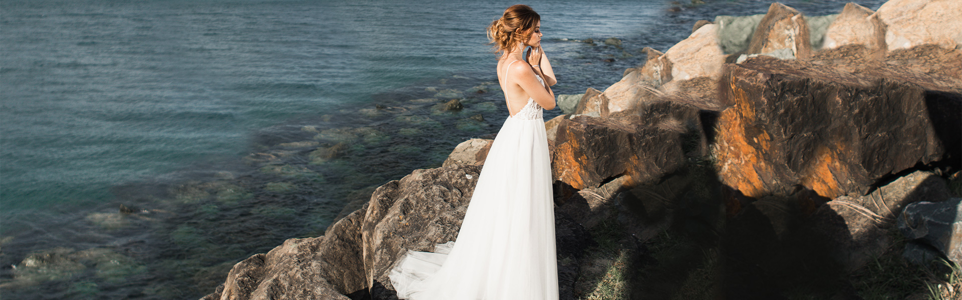 Bride wearing simple a line dress by the ocean