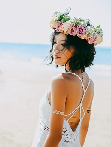 Lovely beach bride sporting sleeveless dress