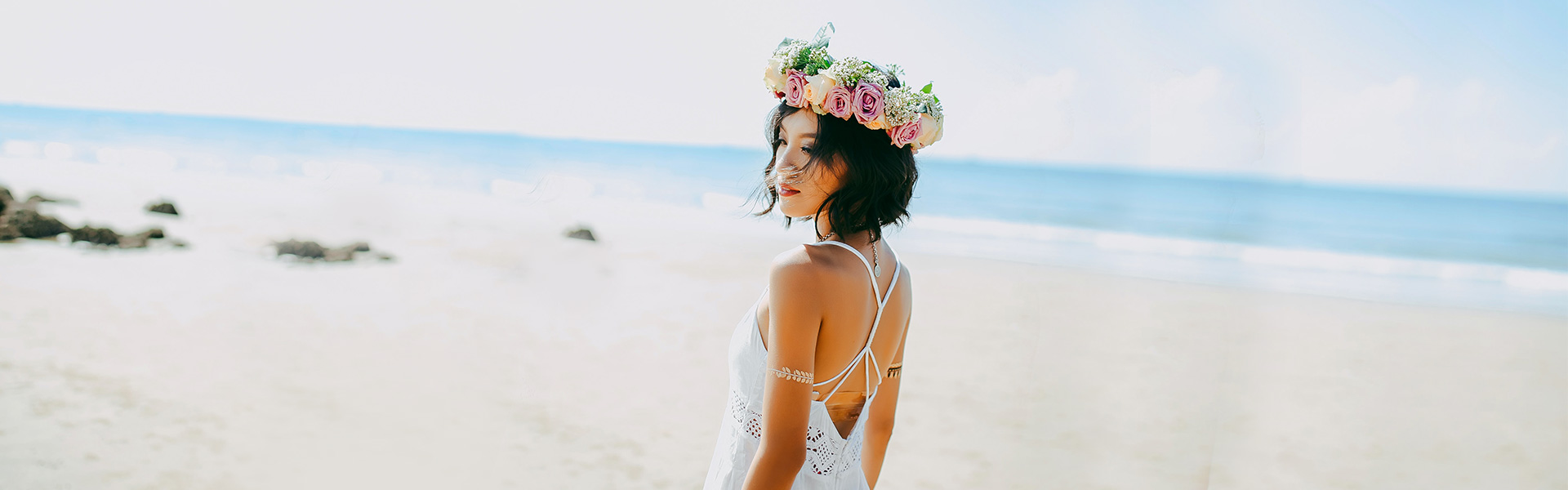 Lovely beach bride sporting sleeveless dress