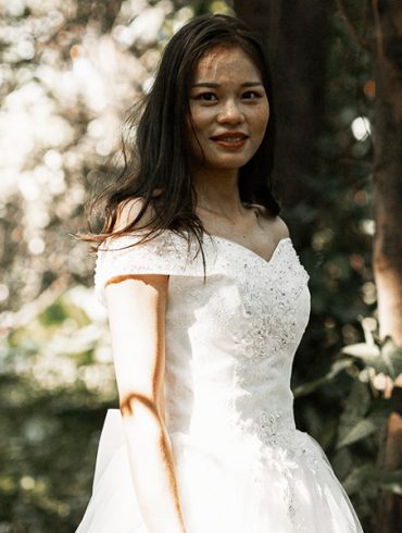 Lovely bride in forest with basque waistline