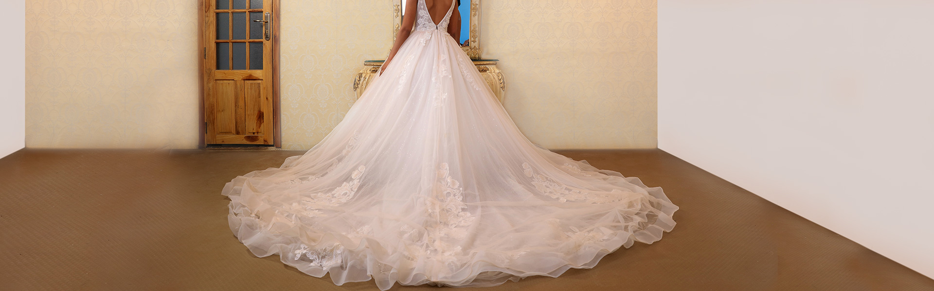 Bride in long dress looking into mirror