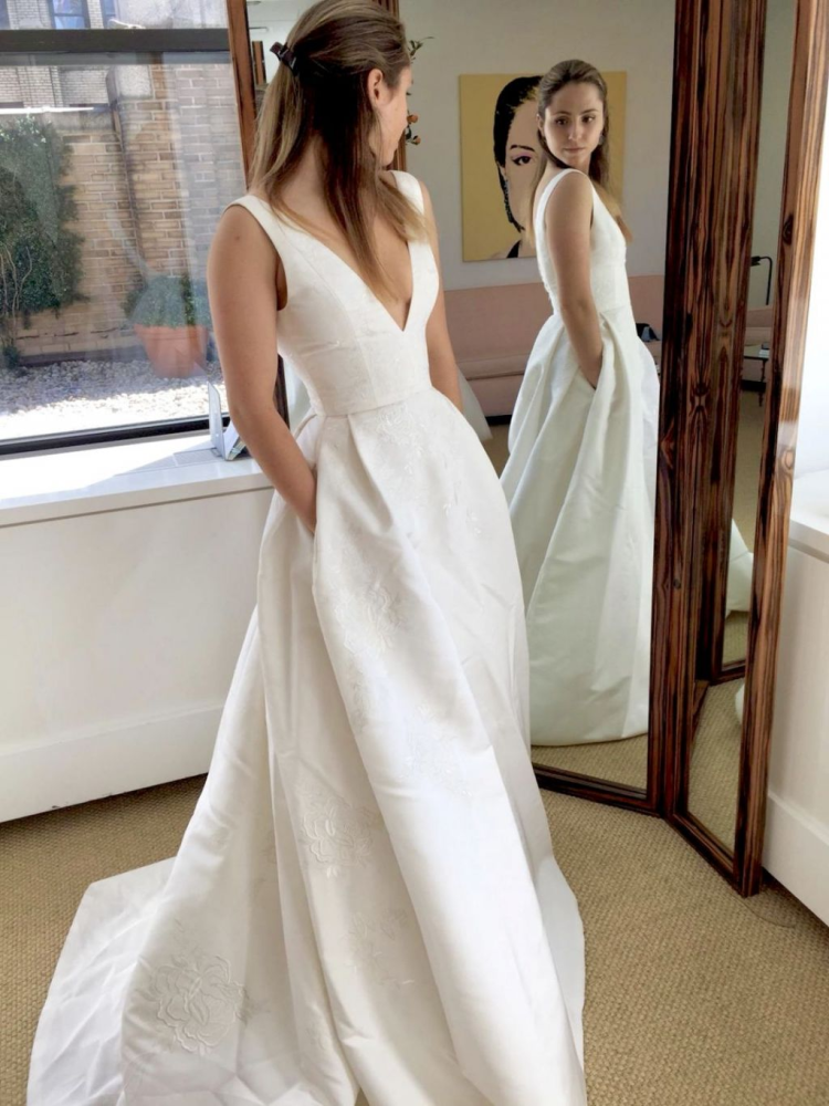 Bride checking out dress with pockets in the mirror