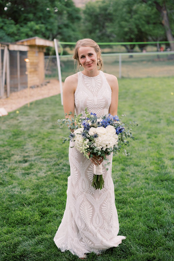 New bride holding flowers in a park
