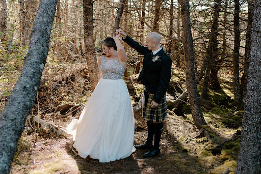 Bride and groom dancing in the forest