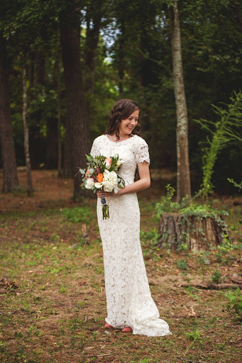 Bride hold flowers in forest
