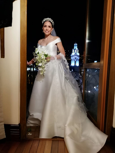 Bride taking photo in front of city skyline