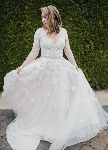 Bride twirling in lacy gown