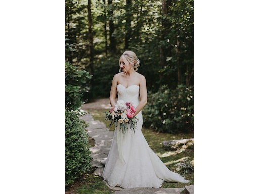 Bride holding flowers in forest