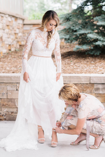 Brides mother helping fix her dress