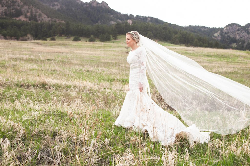 Bride in beautiful dress walking through field