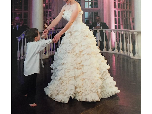 Bride dancing at wedding with small child
