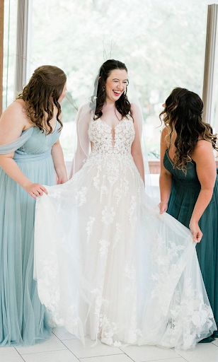 Bridesmaid and brides laughing as they get ready for the wedding ceremony
