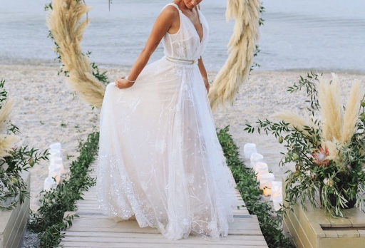 Bride on the beach showing off a lacy gown