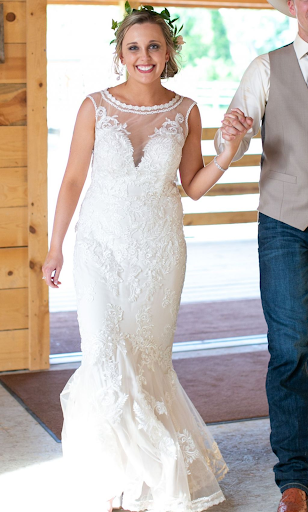 Pretty bride wearing floor length dress in rustic wedding