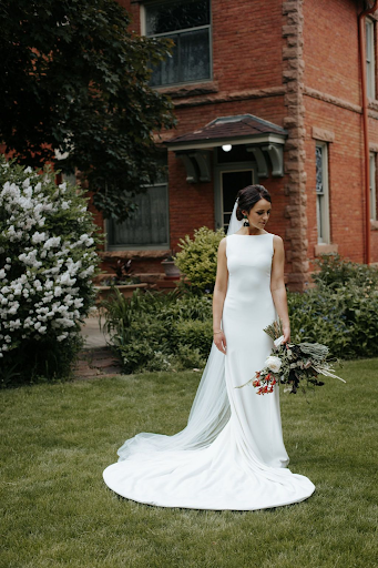 Bride posing for photo in simple, yet elegant wedding dress