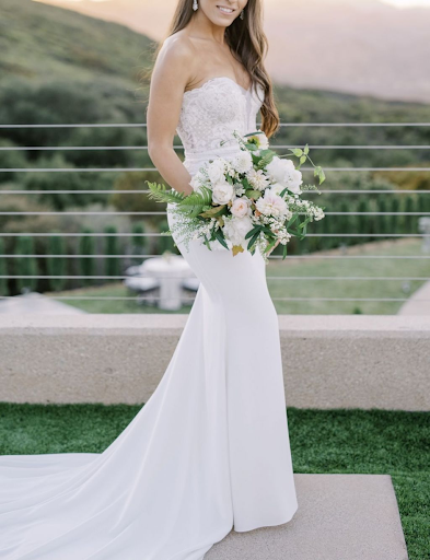 Bride posing in front of vineyard