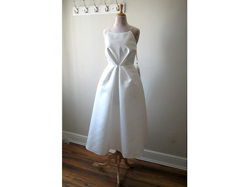 Tea length dress with pinched waistline on a mannequin