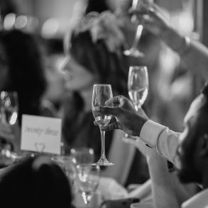 People raising glasses during toast at wedding