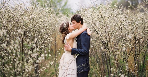 magical-spring-wedding-white-orchard-blossoms-saplings-grove-kiss