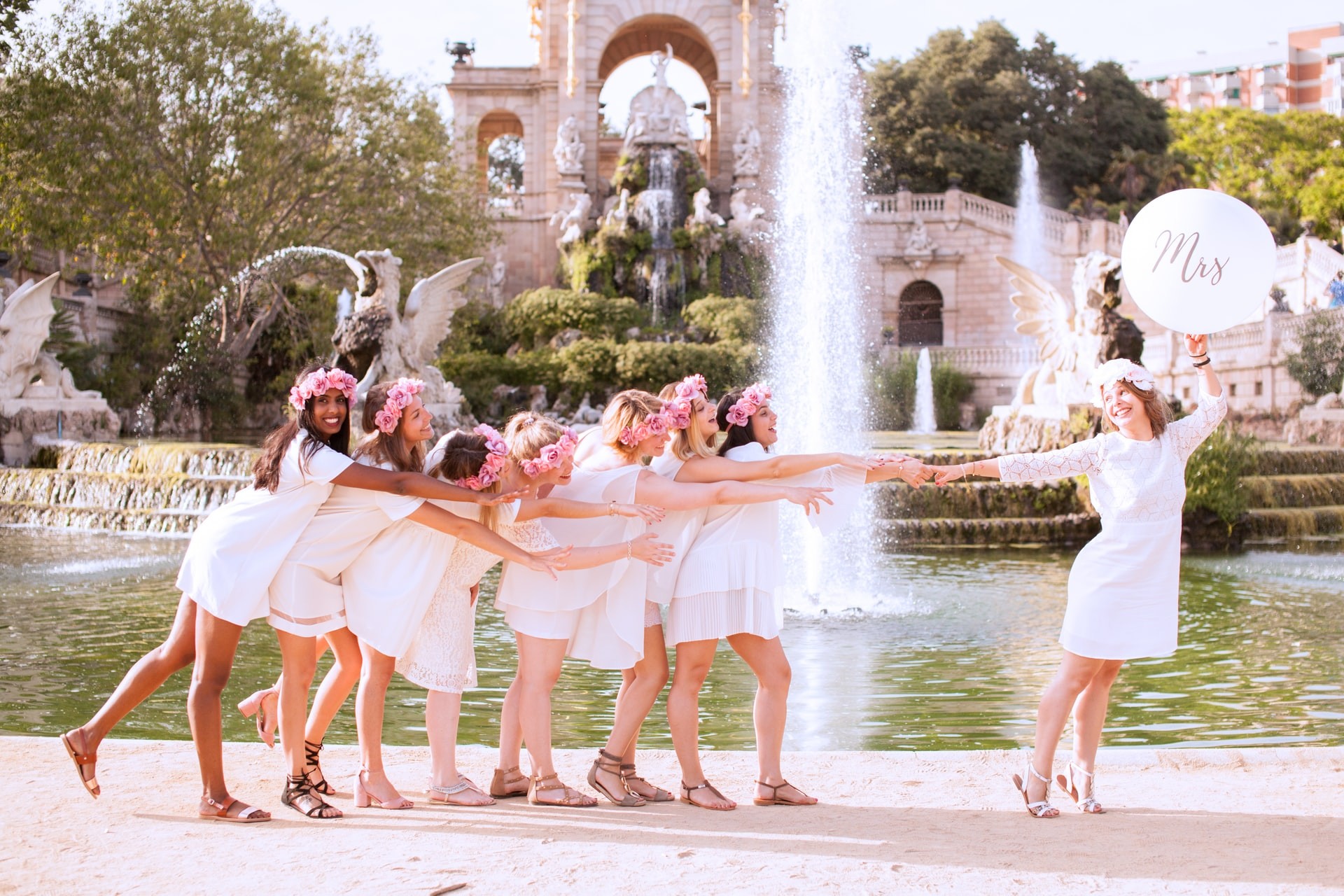 Bride and bridesmaid group photo in front of fountain