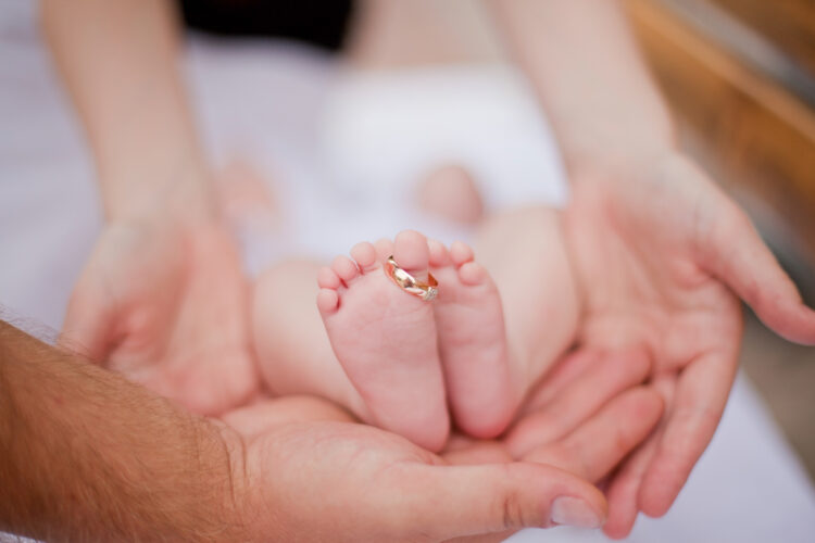Wedding ring on baby's foot