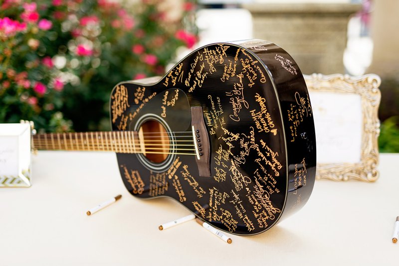 Signatures on a black guitar