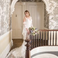 bride posing on wood staircase