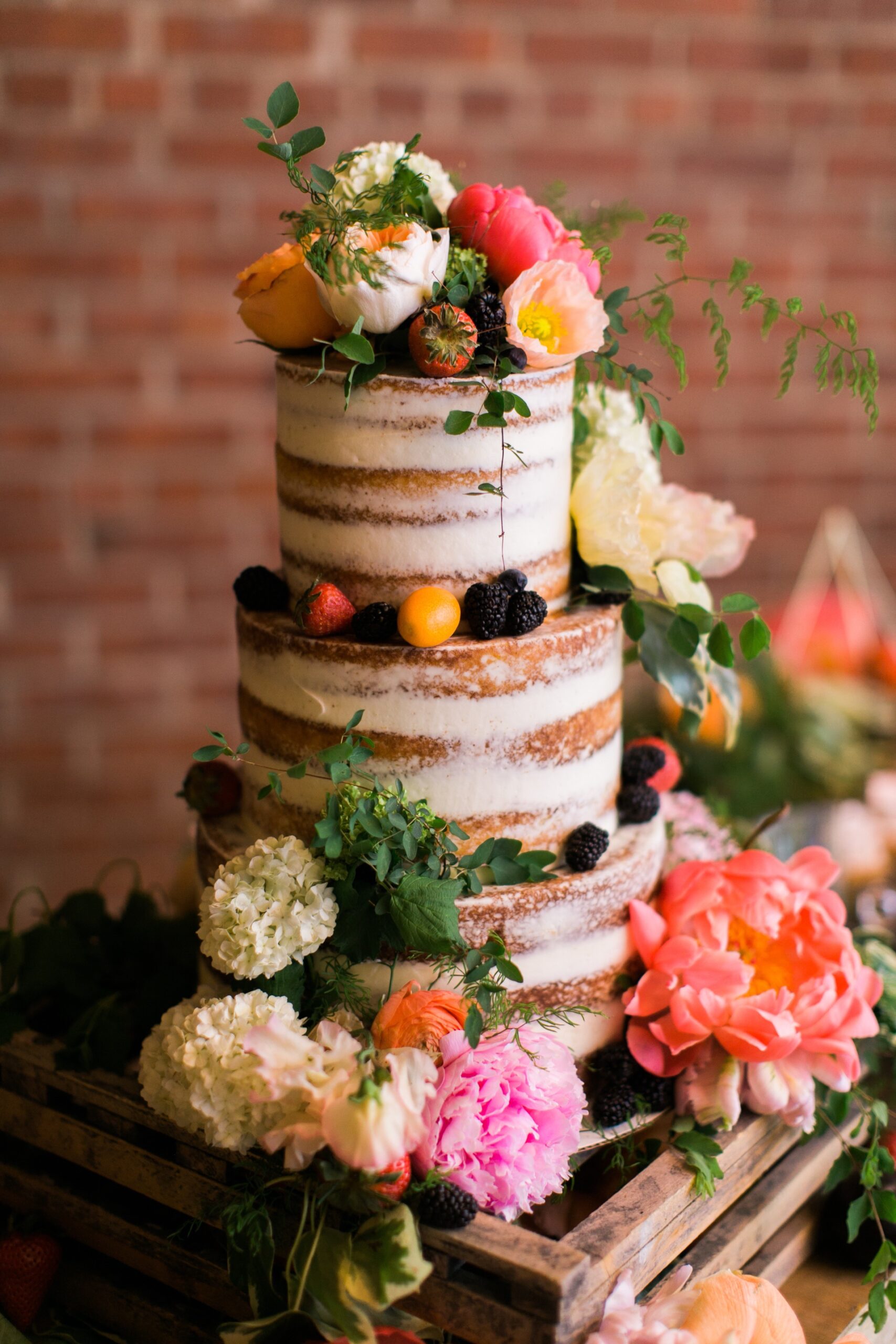 Naked wedding cake with colorful flowers