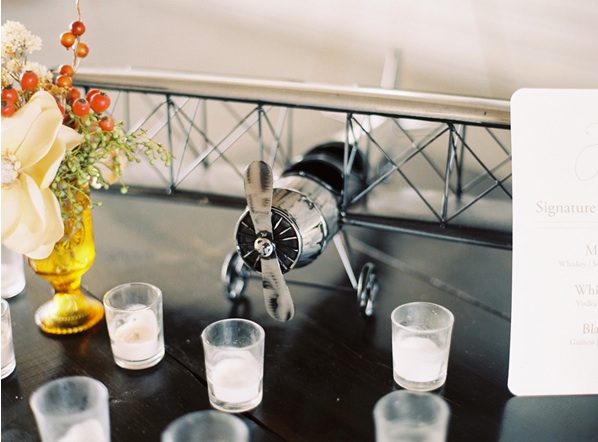 airplane-hanger-wedding-reception-decor-venue-candles-paper-goods