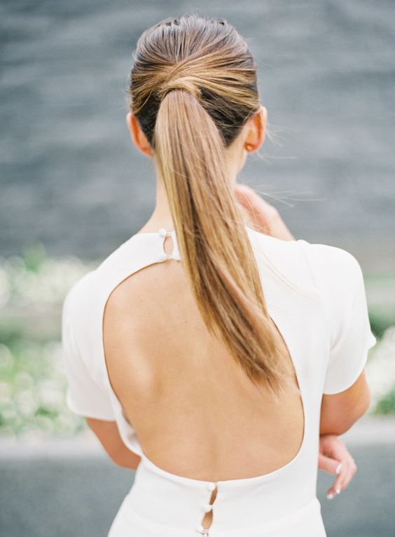 Via Weddingomania Keep it wrapped or add a small braid. Twist the top or leave it bare. A sleek pony works well for those same brides with a modern, chic style. If you aren’t looking for fuss and rather have a bout of simple sensuality, this is it. Messy Bun