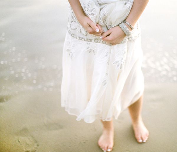 bride-barefoot-beach-sparkling-water