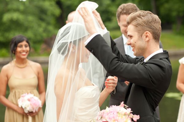 groom-lifting-brides-veil
