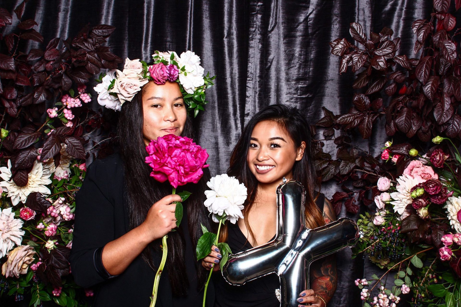 Wedding guests posing with giant fake florals