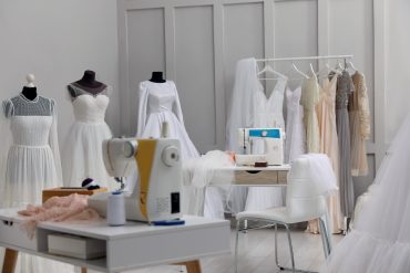 Wedding dresses sitting in a seamstress salon