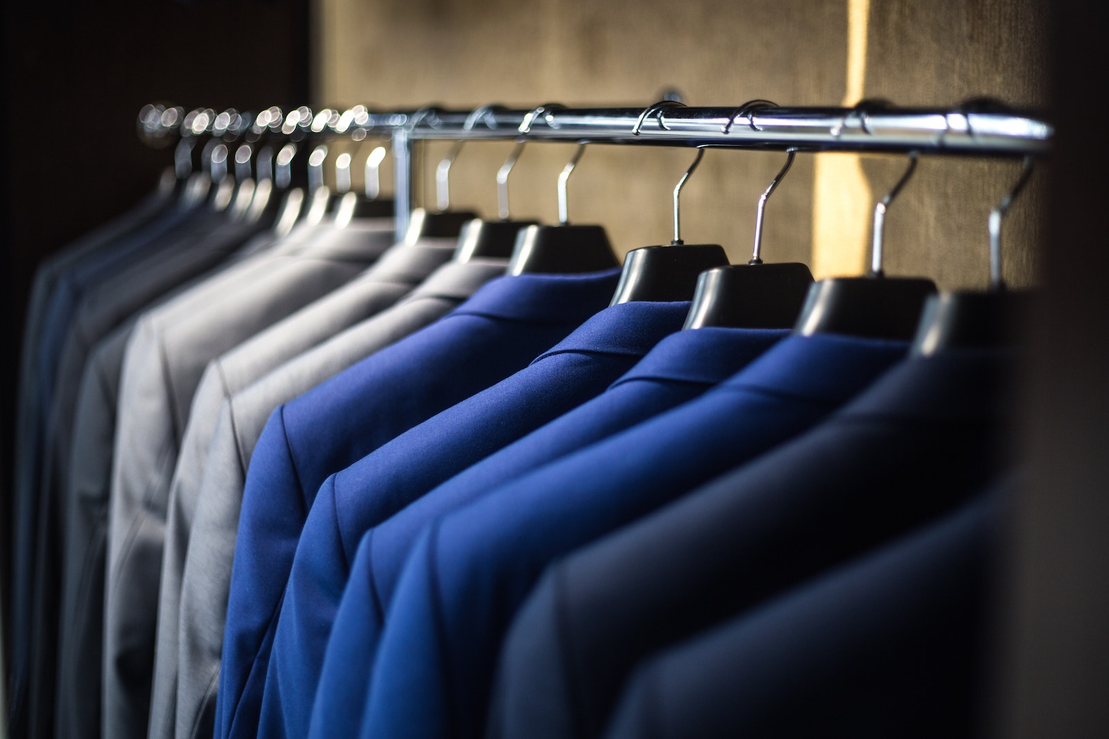Men's suits hanging in a row