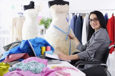 Seamstress measuring a wedding dress