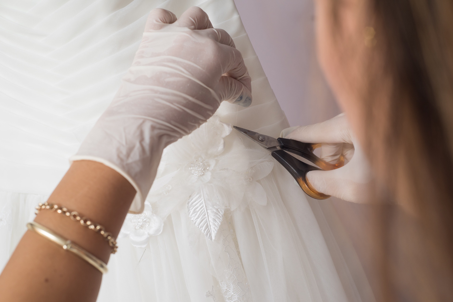 Woman working on a wedding dress repair