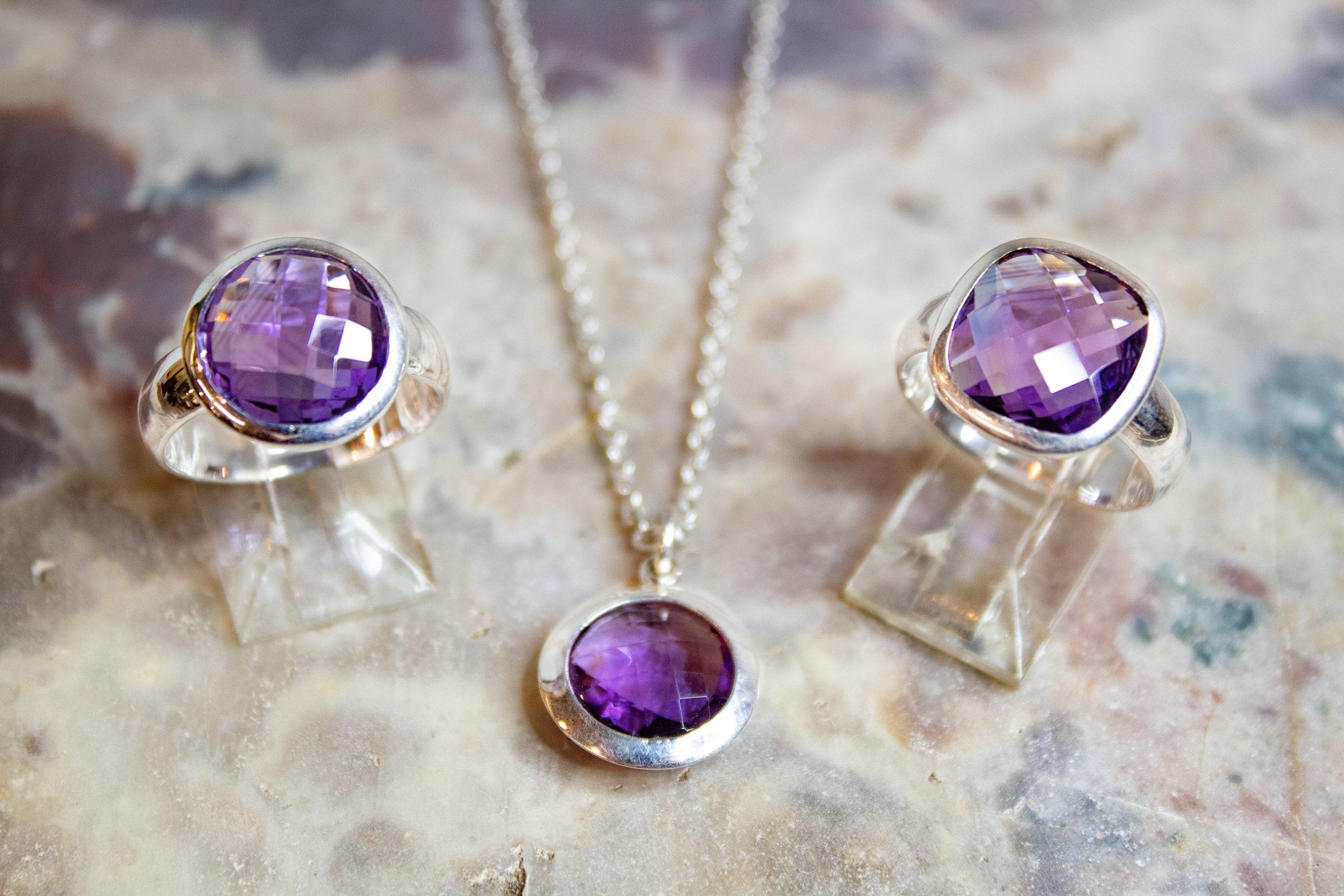 Two round amethyst rings and a necklace