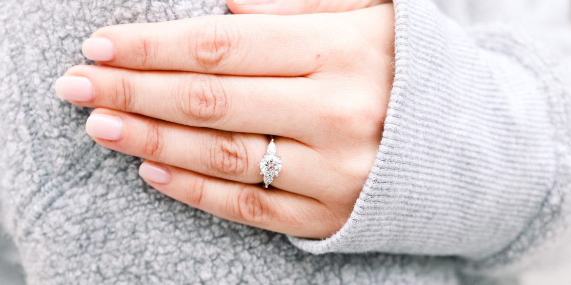 round diamond ring on finger