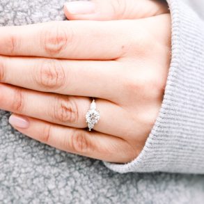 round diamond ring on finger