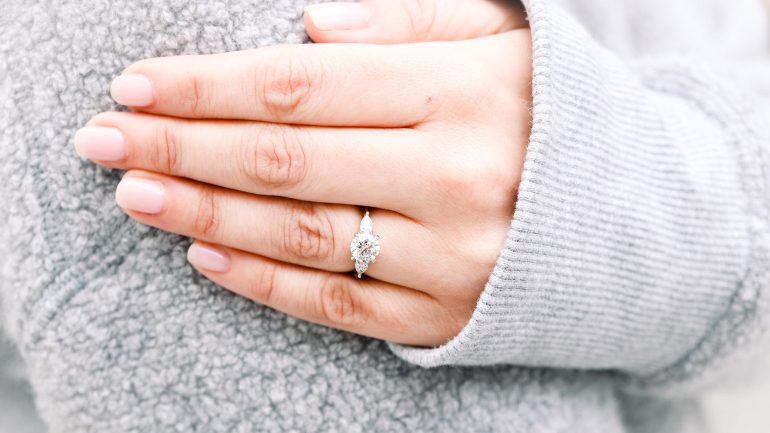 round diamond ring on finger